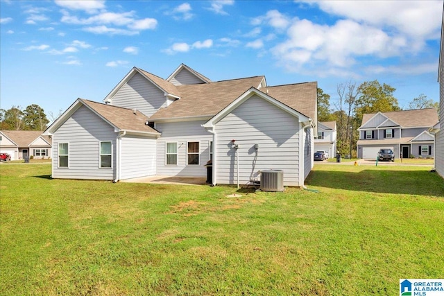 back of house featuring a yard, a patio, and central AC unit