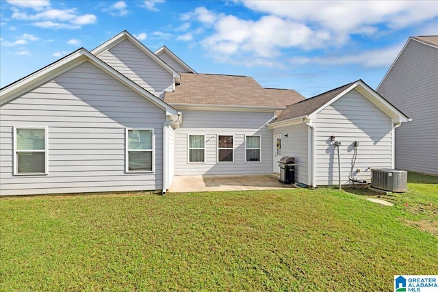 back of property featuring a lawn, a patio area, and central AC