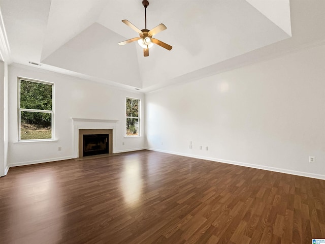 unfurnished living room with ceiling fan, high vaulted ceiling, a wealth of natural light, and dark hardwood / wood-style floors