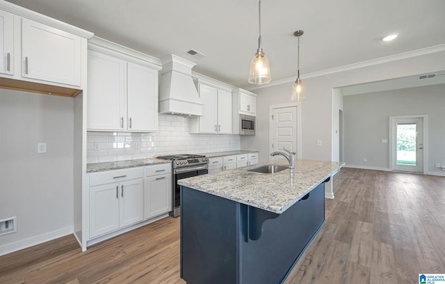 kitchen with appliances with stainless steel finishes, white cabinets, and sink