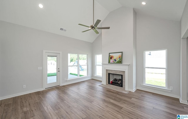 unfurnished living room featuring high vaulted ceiling, hardwood / wood-style floors, and ceiling fan