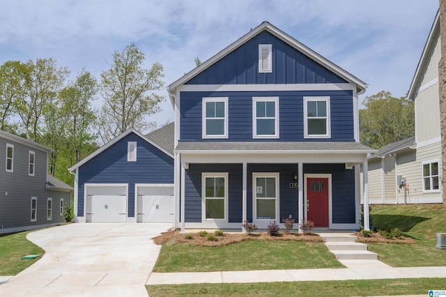 194 Barimore Blvd, Helena, AL 35080 - view of front of home featuring board and batten siding, covered porch, an attached garage, concrete driveway, and a front yard