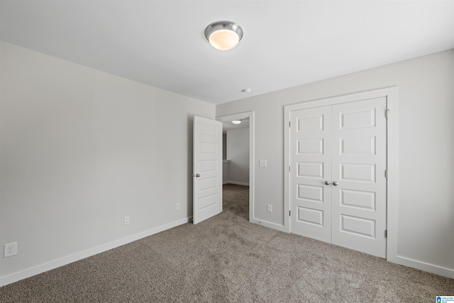 unfurnished bedroom featuring carpet flooring and a closet