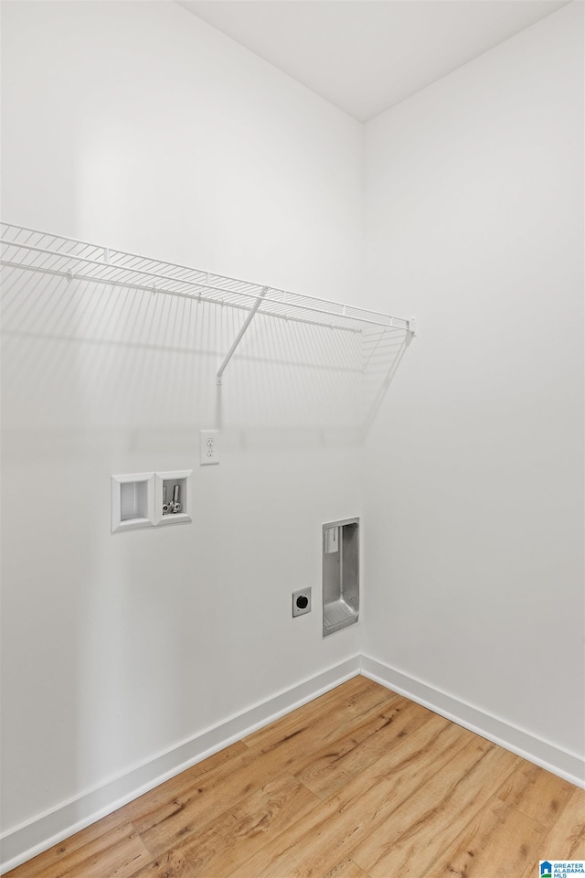 clothes washing area featuring hookup for a washing machine, electric dryer hookup, and wood-type flooring