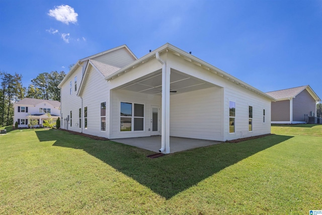 rear view of house featuring a yard and a patio area