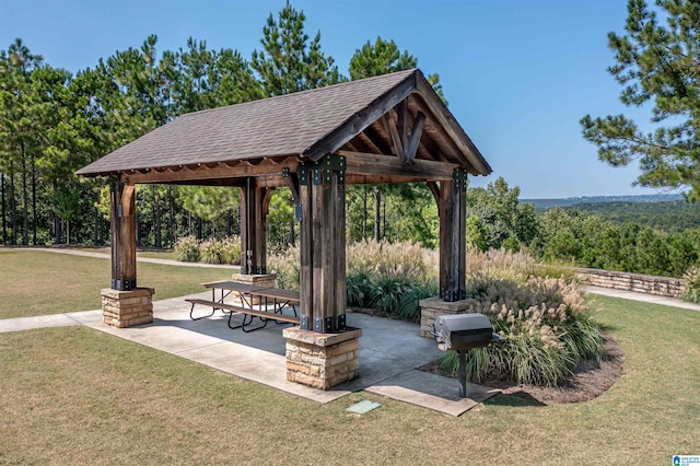 view of property's community with a gazebo, a patio area, and a lawn