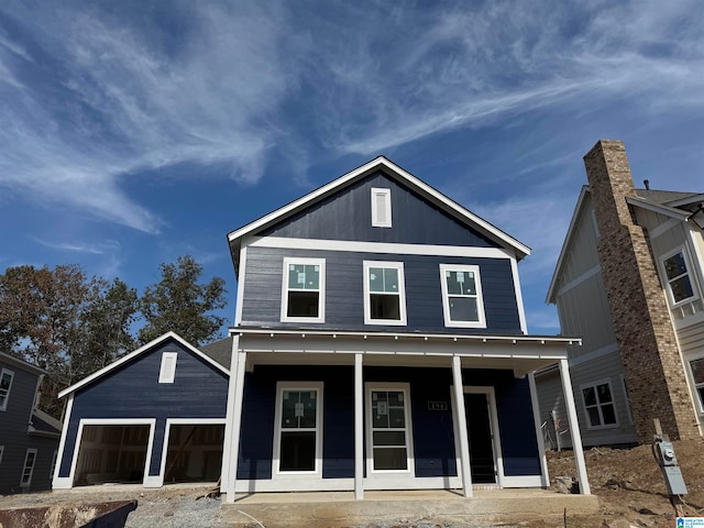 view of front facade with covered porch and a garage