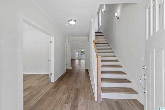 interior space with crown molding and light hardwood / wood-style flooring