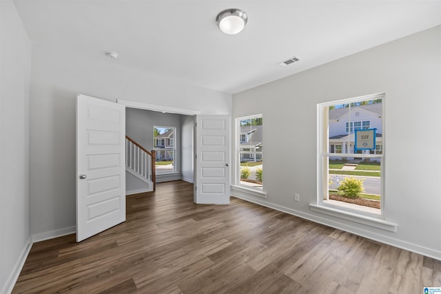 unfurnished room featuring dark hardwood / wood-style flooring