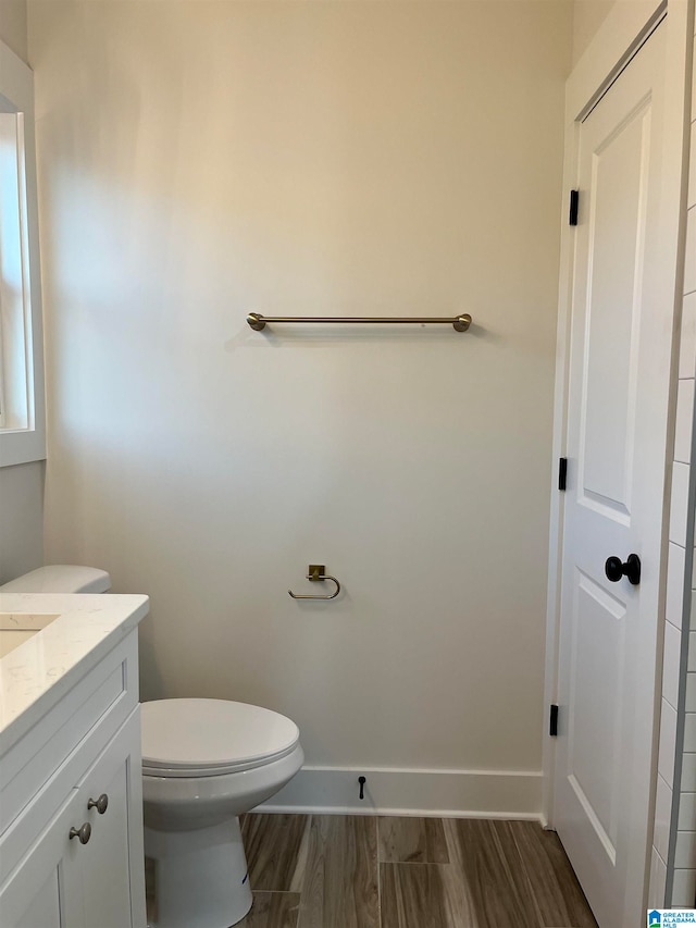 bathroom featuring vanity, toilet, and wood-type flooring