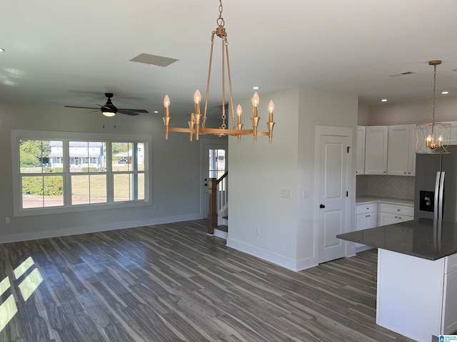 kitchen with pendant lighting, stainless steel fridge, dark hardwood / wood-style floors, and white cabinets