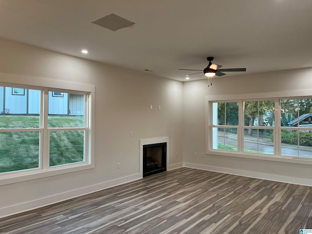 unfurnished living room with ceiling fan and dark hardwood / wood-style flooring