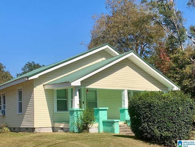 view of side of property with a yard