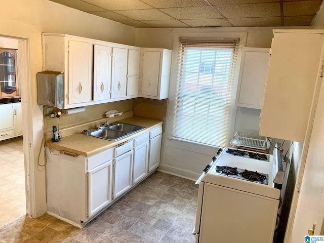 1304 2nd Ave N, Clanton, AL 35045 - kitchen with a sink, white range with gas cooktop, white cabinetry, and light countertops