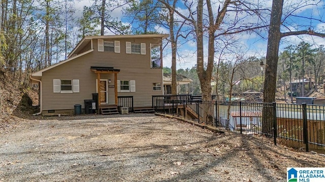 exterior space with crawl space, fence, and a deck