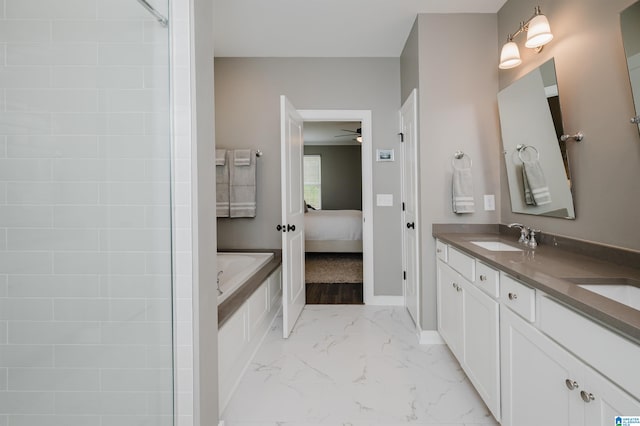 bathroom featuring vanity, ceiling fan, and independent shower and bath