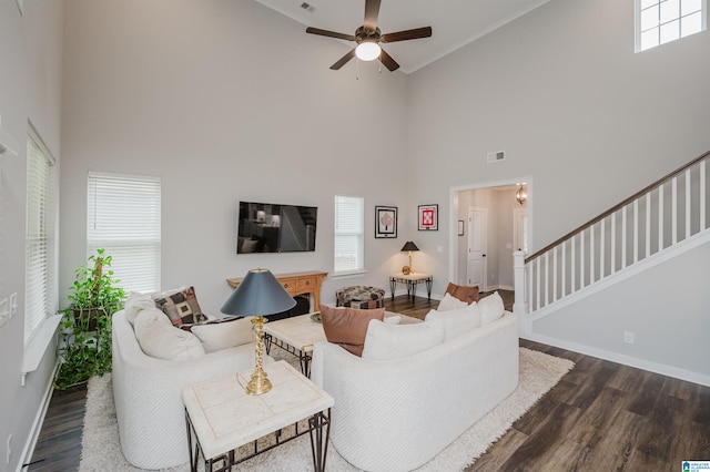 living room featuring a high ceiling and a healthy amount of sunlight