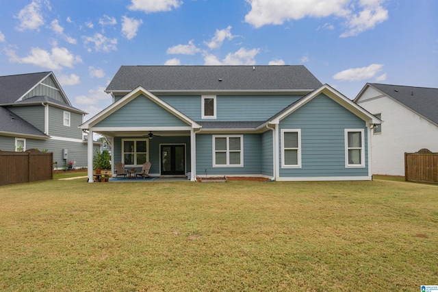 back of house with a patio area, a lawn, and ceiling fan