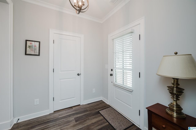 foyer featuring ornamental molding, an inviting chandelier, and dark hardwood / wood-style floors