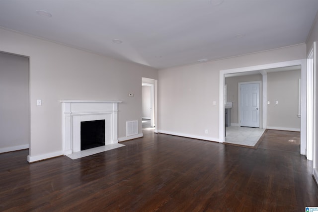 unfurnished living room featuring dark wood-type flooring