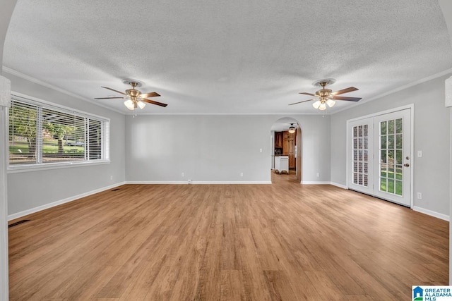 unfurnished living room with a textured ceiling, ornamental molding, light hardwood / wood-style floors, and ceiling fan