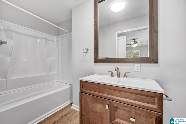 bathroom with shower / tub combination, vanity, and hardwood / wood-style floors