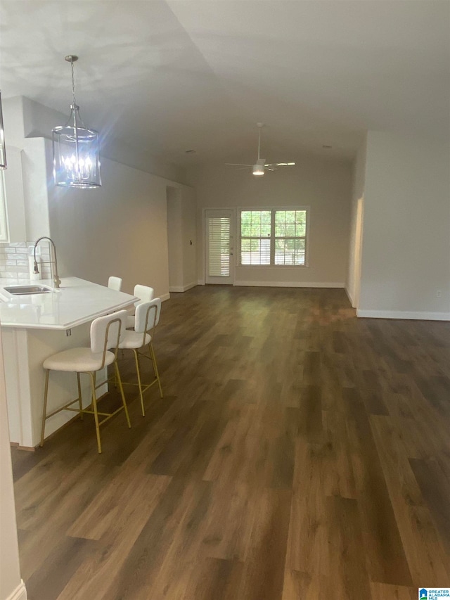 interior space featuring ceiling fan with notable chandelier, sink, and dark hardwood / wood-style floors