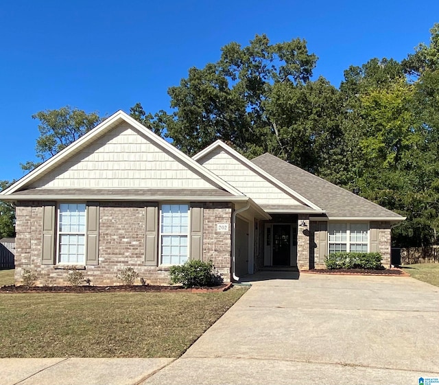 view of front of property with a front yard and a carport