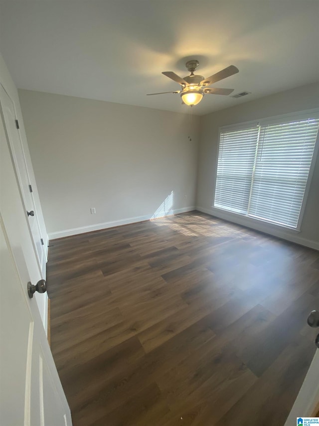 spare room featuring ceiling fan and dark hardwood / wood-style flooring