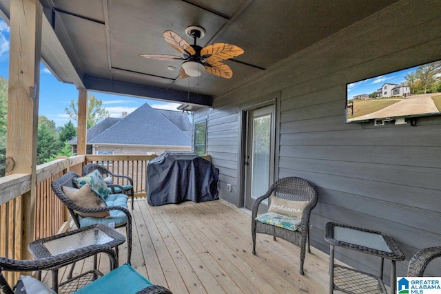 wooden deck with area for grilling and ceiling fan