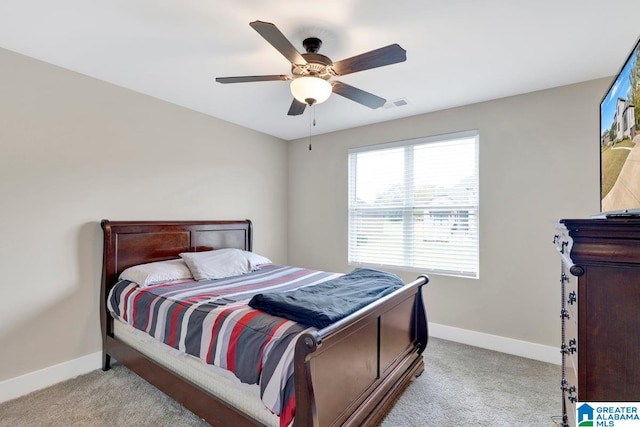 bedroom with ceiling fan and light carpet