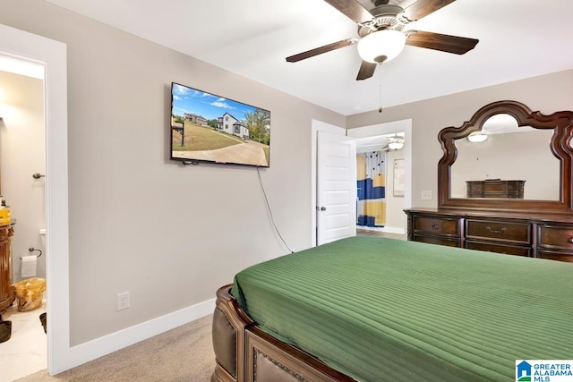 carpeted bedroom featuring ensuite bath and ceiling fan