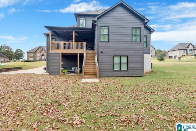 back of property featuring a patio area and a lawn