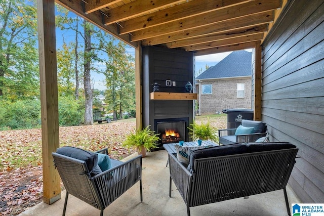 view of patio featuring an outdoor living space with a fireplace