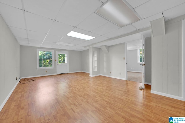 unfurnished room with a drop ceiling and light hardwood / wood-style flooring