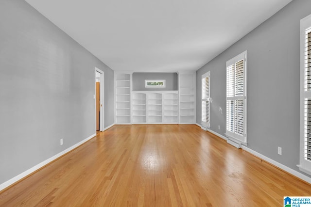 empty room with light hardwood / wood-style flooring