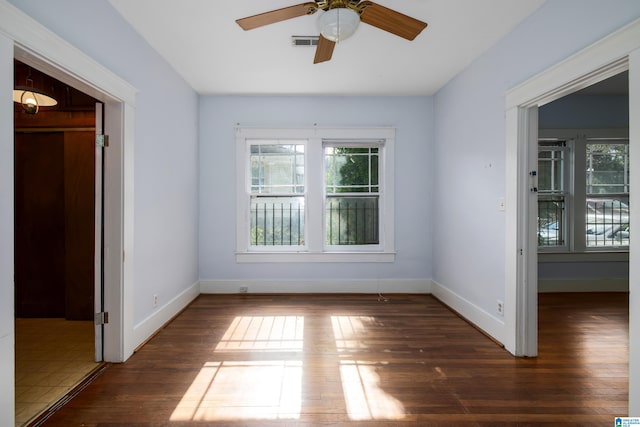 empty room featuring dark hardwood / wood-style flooring and ceiling fan