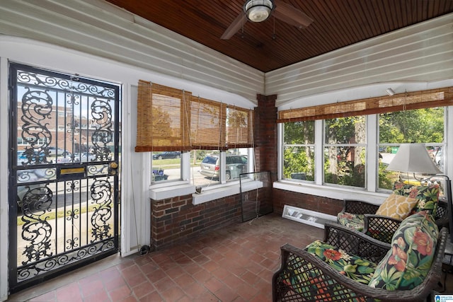 sunroom with a wealth of natural light, wooden ceiling, and a ceiling fan