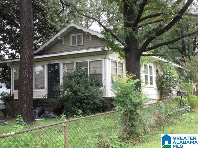 view of side of property featuring fence