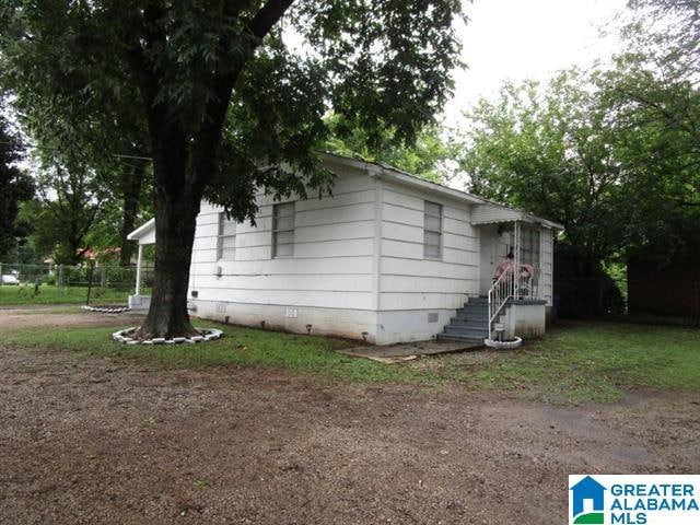 view of home's exterior featuring fence and crawl space