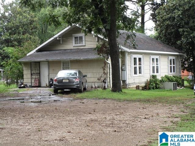 bungalow-style house with central AC unit