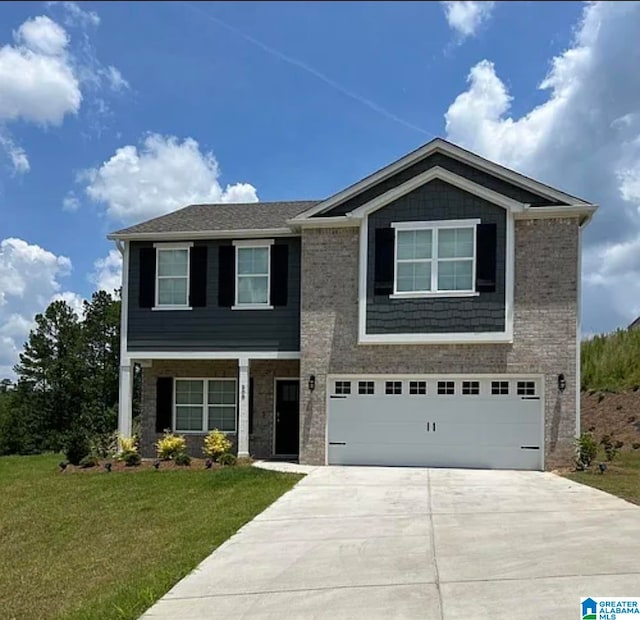 view of front of property with a garage and a front lawn