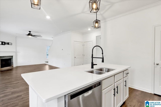 kitchen with dishwasher, a kitchen island with sink, white cabinets, sink, and hanging light fixtures