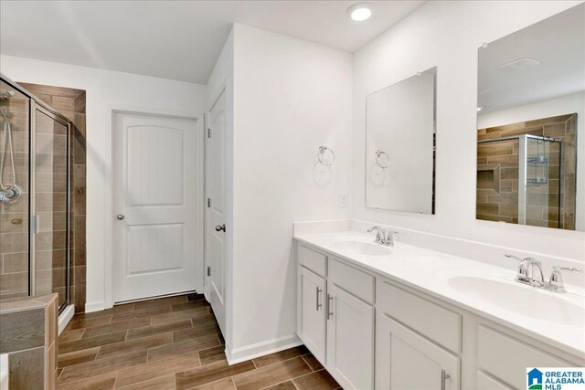 bathroom featuring vanity and an enclosed shower