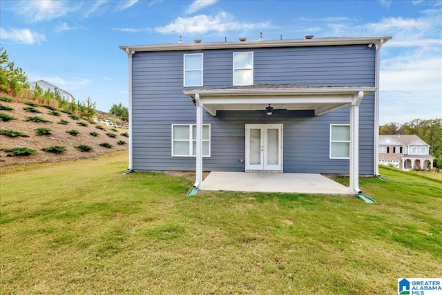 back of property featuring ceiling fan, a patio area, and a lawn