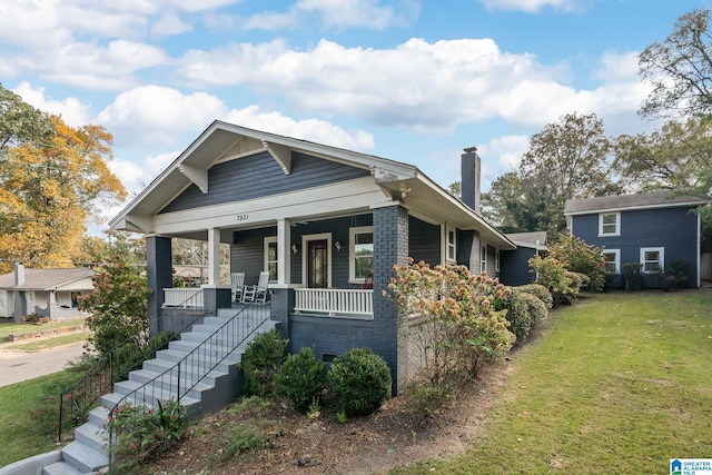 view of front of property with a front yard and covered porch