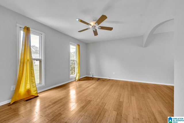 spare room featuring light hardwood / wood-style flooring and ceiling fan