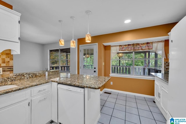 kitchen featuring white cabinetry, kitchen peninsula, dishwasher, and a healthy amount of sunlight