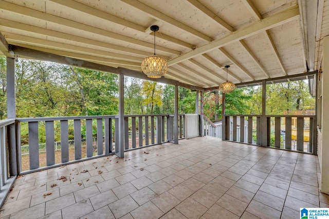 unfurnished sunroom with lofted ceiling and plenty of natural light