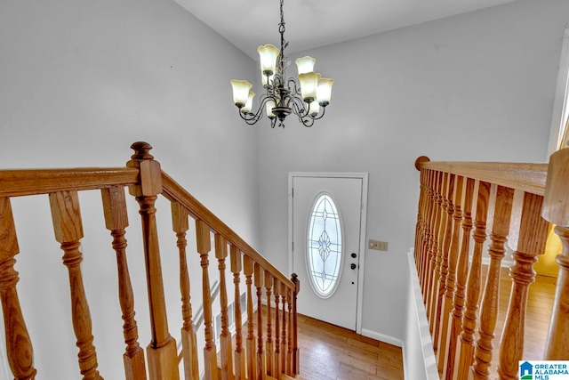 foyer featuring hardwood / wood-style floors and a notable chandelier